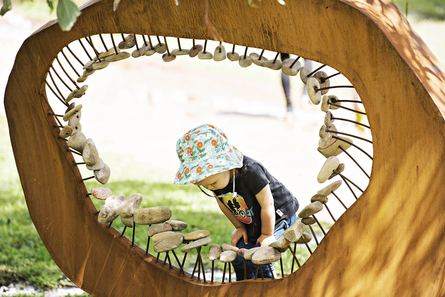 child looking at sculpture